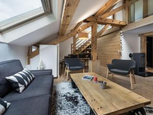 a living room with a couch and a wooden table at Superbe duplex central à Méribel pour 8 pers, proche pistes - FR-1-565-16 in Les Allues +2 photos