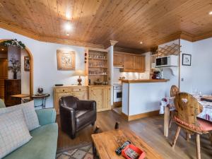 a living room with a couch and a table at Appartement Méribel, 3 pièces, 4 personnes - FR-1-565-19 in Les Allues