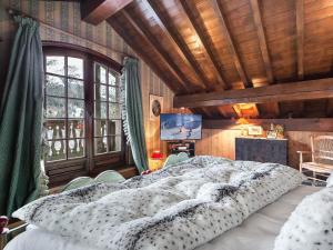 a bedroom with a large bed and a large window at Chalet chaleureux avec jacuzzi, hammam et salle de jeux à Mussillon - FR-1-565-40 in Les Allues