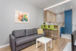 a living room with a couch and a table at Chill Apartments Warsaw Airport in Warsaw