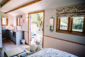 a kitchen with a bed in a room with a window at Snowdrop Lodge, Walcot Hall Estate in Alkborough