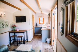 a small kitchen with a table and a sink at Snowdrop Lodge, Walcot Hall Estate in Alkborough