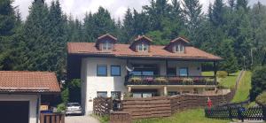 a house with a fence in front of it at Ferienwohnung Schmidt in Bayerisch Eisenstein