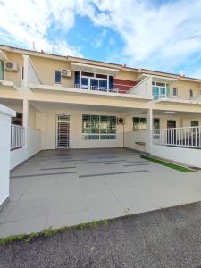 a large driveway in front of a house at Spacious Family House at Desaru Harmonia 2 in Desaru