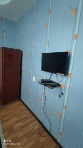 a computer monitor on a shelf in a room at Umid Hostel in Bukhara