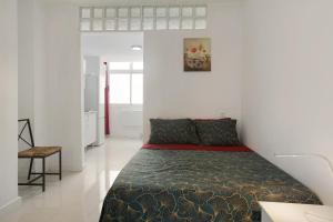 a bedroom with a bed in a white room at Estudio Massimo 7c in Las Palmas de Gran Canaria