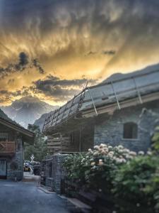 a view of a building with mountains in the background at La Tanière in Morgex