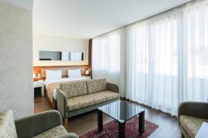 a hotel room with a bed and a couch and a table at P Galata Hotel - Special Category in Istanbul