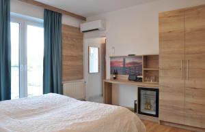 a bedroom with a bed and a fireplace at Seehotel Herlinde in Podersdorf am See