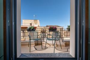 a view from a window of a balcony with chairs at BED 10.5 - DESIGN SUITE in Castellammare del Golfo