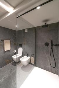 a bathroom with a toilet and a sink and a shower at Appartamento Scalinata San Rocco in Limone sul Garda
