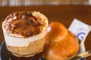 a drink on a plate next to a bread at Bottari Rooms Panarea in Panarea