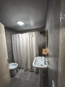 a bathroom with a sink and a toilet and a shower at San Bernardo Surf apartment in San Bernardo +8 photos