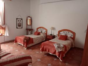 a bedroom with two beds and a mirror at El Sabinar in Vallehermoso