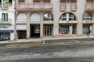 an empty street in front of a building at APPARTEMENT CENTRE VILLE PARKING COUVERT WIFI BALCON in Cauterets