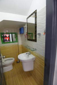a bathroom with a sink and a toilet and a mirror at CHIENHOA HOMESTAY in Danang +25 photos
