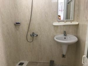 a bathroom with a sink and a shower with a mirror at Nhà nghỉ Phương Dung in Phu Quoc