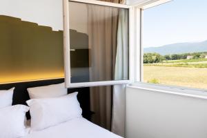 Rúm í herbergi á B&B HOTEL Nyon