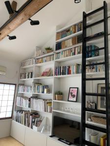 a room with white shelves filled with books at Gion Jizo in Kyoto