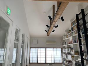 a room with bookshelves and a large window at Gion Jizo in Kyoto