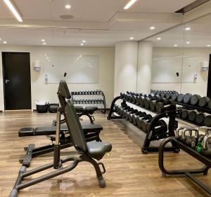 a gym with rows of chairs and treadmills at Quality Hotel Globe in Stockholm