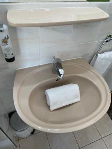 a white toilet with a white towel sitting on it at Hotel Tabor Rooms in Vienna