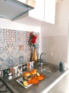 a kitchen counter with a plate of food on a sink at Historic Centre - Apartment Near Teatro Massimo in Palermo +9 photos
