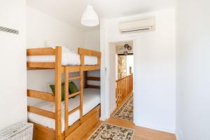 a room with bunk beds and a hallway at Beautiful House in Miranda do Corvo