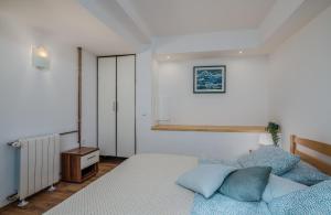 a bedroom with a bed with blue pillows at Apartments Dorotea in Krk