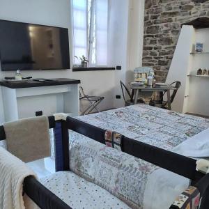 a bedroom with two beds and a flat screen tv at Civico29 Rooms & Breakfast in Como