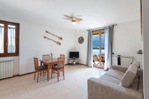 a living room with a couch and a table at View House - Lake Como in Pescate