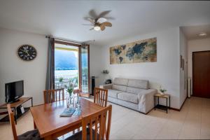 a living room with a table and a couch at View House - Lake Como in Pescate