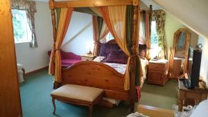 a bedroom with a canopy bed with a bench in it at Shiralee bed and breakfast in Salisbury