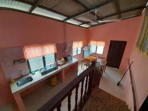 a kitchen with a counter and a sink in a room at AMZ WOODHOMESTAY AT GONG KIAT, KUALA TERENGGANU in Kuala Terengganu