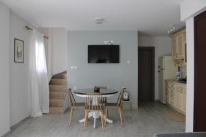 a kitchen and dining room with a table and chairs at Urban Chic Apartments Lefkada in Lefkada Town