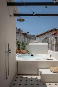 a bathroom with a large tub in a room at 72 AD Suites in Thessaloniki