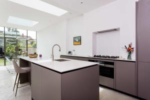 a kitchen with a sink and a counter top at Veeve - Quartz House in London