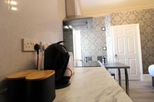 a backpack sitting on top of a counter in a kitchen at The Gwydir Ground Floor Studio in Llandudno