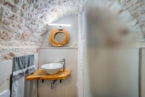 a bathroom with a sink and a mirror at D House in Ceglie Messapica