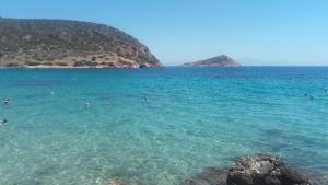 a group of people swimming in the water at KimonVilla in Porto Rafti