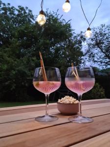 two glasses of wine sitting on a table at Bij Ons Naast in Nuenen +6 photos