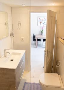 a bathroom with a sink and a toilet and a table at Studio Excellent 21 in Soesterberg