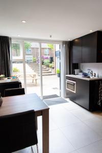 a kitchen with a table and a dining room at Studio Excellent 21 in Soesterberg