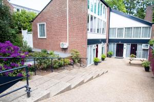 a brick building with a staircase in front of it at Studio Excellent 21 in Soesterberg