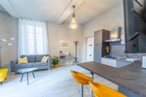 a kitchen and living room with a couch and a table at Parma Central Apartments in Parma