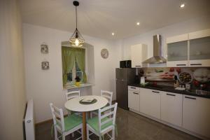 a kitchen with a table and chairs in a room at Villa Fani in Rijeka