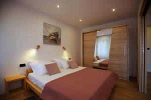 a bedroom with a large bed and a sliding glass door at Villa Fani in Rijeka