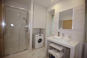 a bathroom with a sink and a washing machine at Villa Fani in Rijeka +23 photos