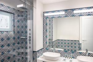 a bathroom with a sink and a mirror at Pazziella Garden & Suites in Capri