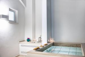 a bathroom with a tub in the middle of a room at Pazziella Garden & Suites in Capri